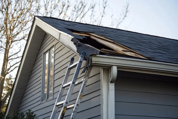 broken-gutters-front-closeup-roof-ladder-single-family-home-repair
